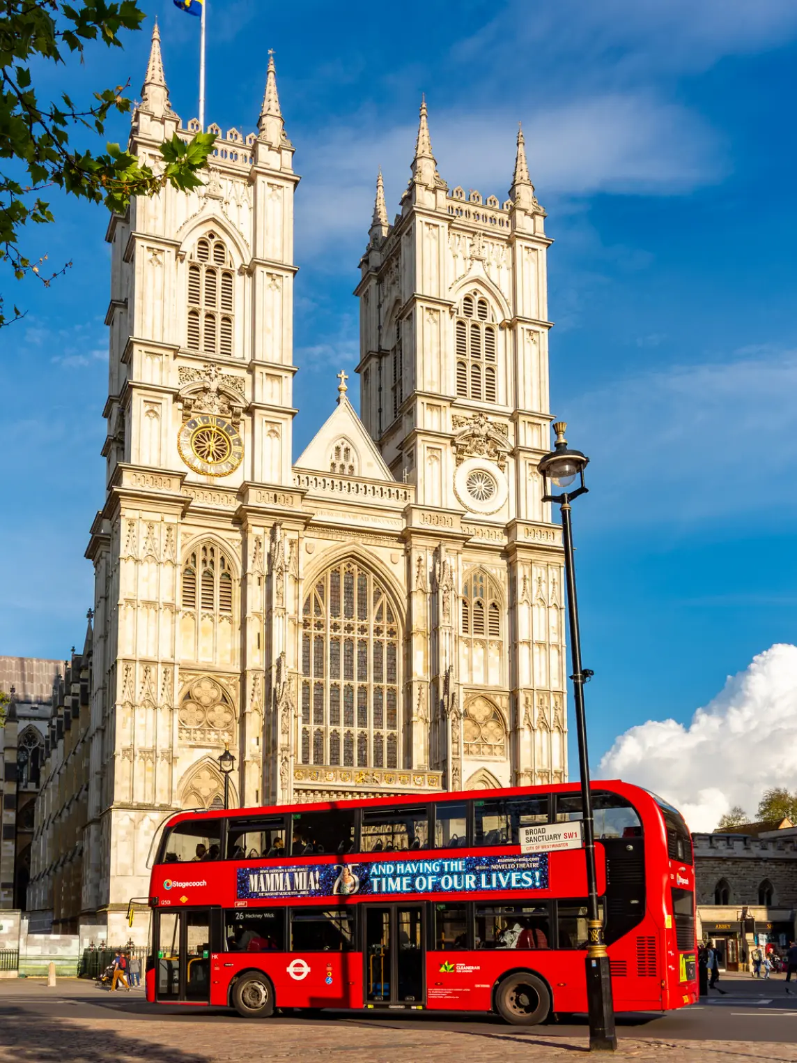 Westminster Abbey with its twin western towers and elaborate Gothic architecture, featuring pointed arches and ornate stonework