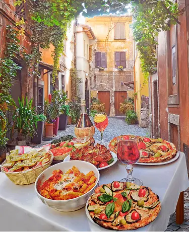 A summer dinner .Pasta , pizza and homemade food arrangement in a restaurant Rome .Tasty and authentic Italian food.