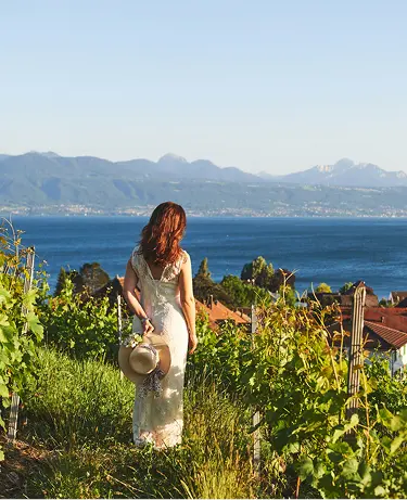 Woman enjoying nice view on Lake Geneva from Lavaux vineyards, Lausanne, Canton of Vaud, Switzerland