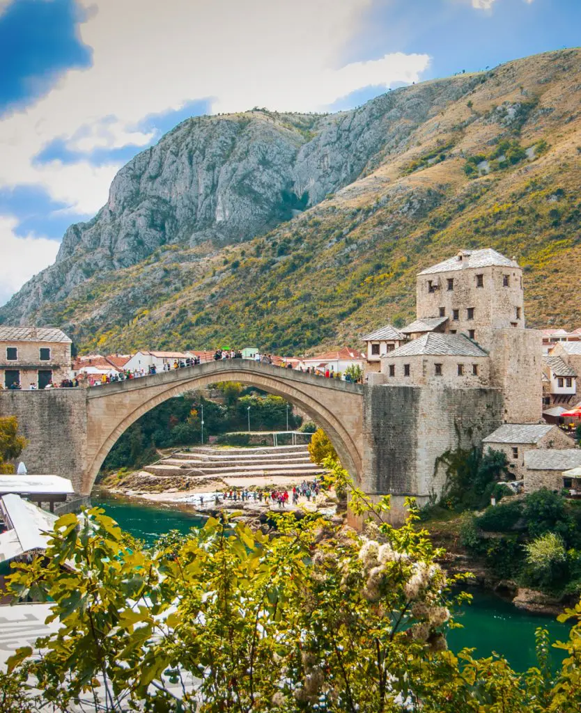 Panoramic aerial view of the historic town of Mostar with famous Old Bridge (Stari Most), a UNESCO World Heritage Site since 2005, on a rainy day with dark clouds in summer, Bosnia and Herzegovina
