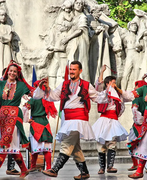 Traditional folk dancers performing in Budapest wearing embroidered costumes and colorful cultural attire