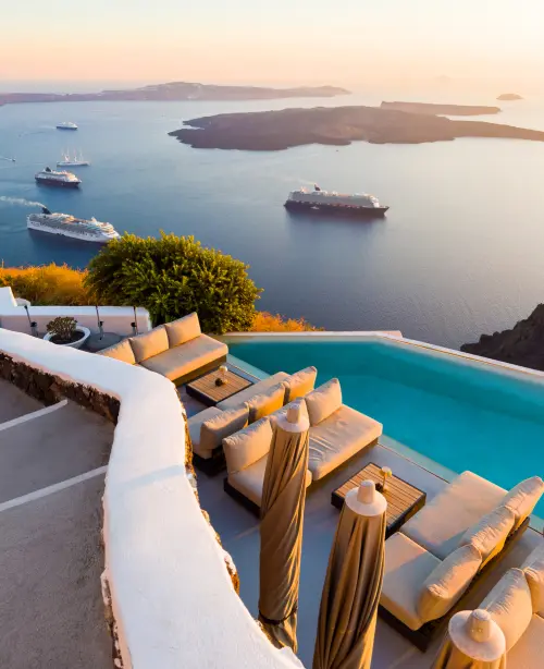 Luxury resort in Santorini featuring whitewashed architecture, infinity pool, and panoramic Aegean Sea views.