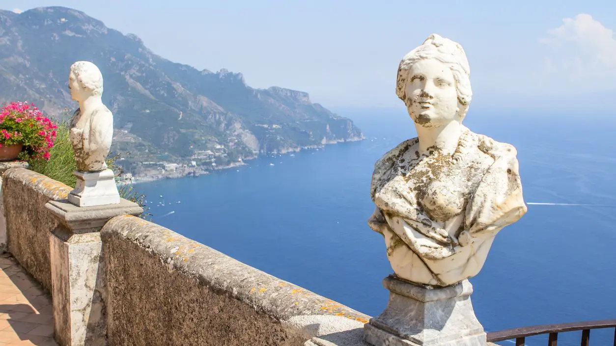 Stone statues on the sunny Terrace of Infinity in Villa Cimbrone with spectacular views of the sea and the Amalfi Coast. 