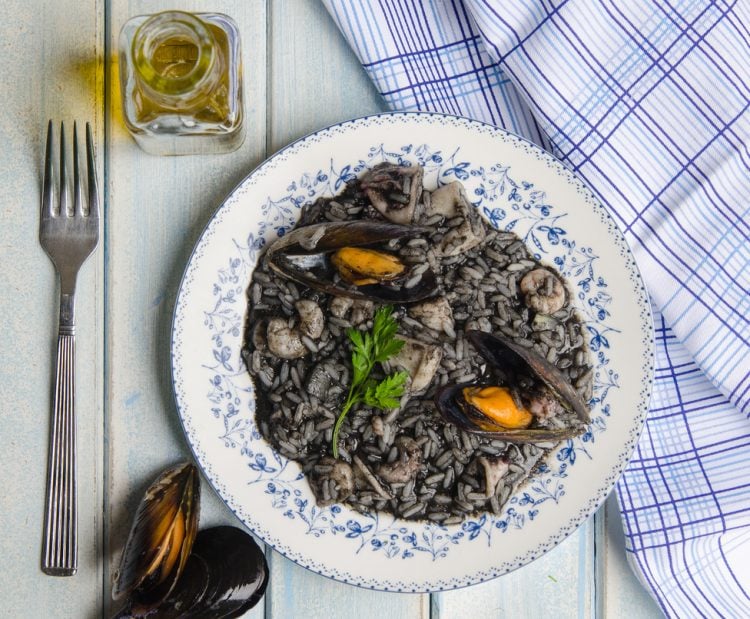 Black rice with squid, squid ink, prawns, cockles and olive oil.