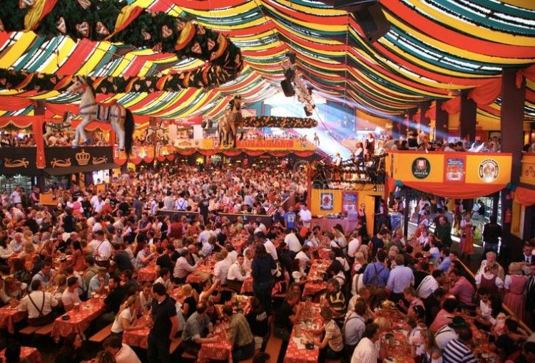 Colorful Munich Oktoberfest tent scene with packed tables