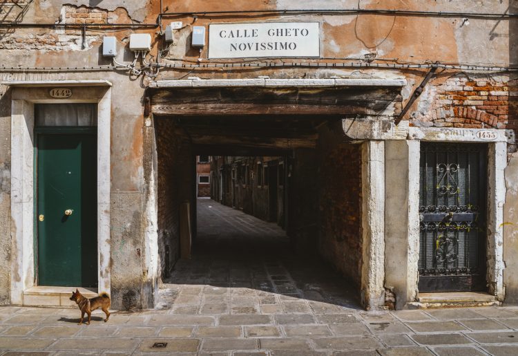 Venice, Italy - March 28, 2018: Entrance to an ancient alleyway in the traditional Jewish ghetto of Venice located in the Cannaregio district. Calle Gheto Novissimo in English means New Ghetto Street