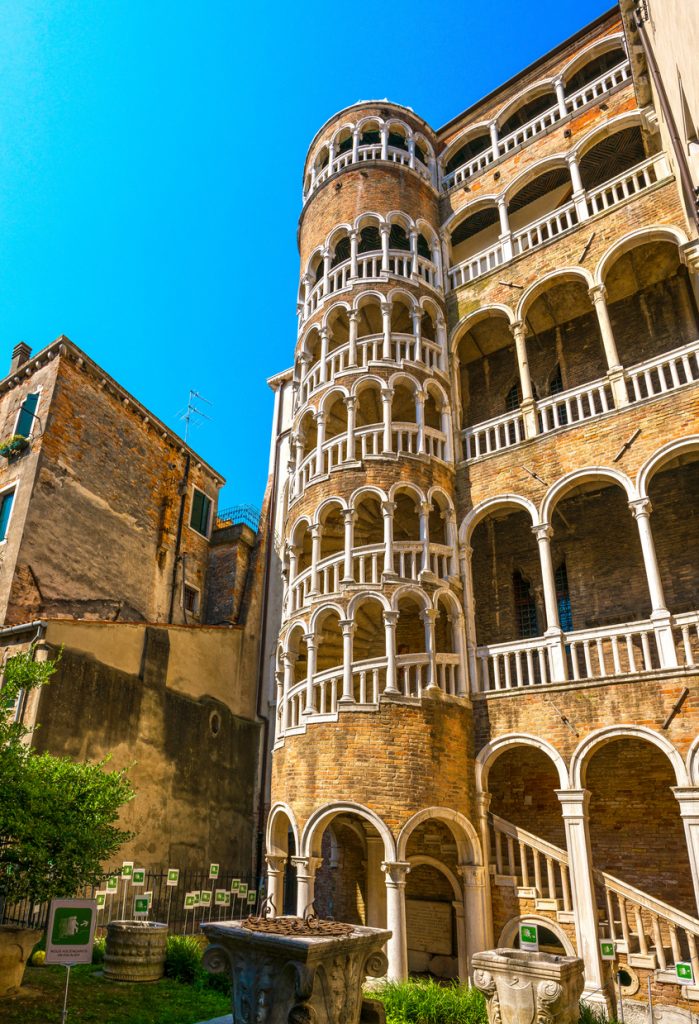 VENICE / ITALY - JUNE 20, 2017: View of Palazzo Contarini del Bovolo with multi arch spiral staircase. The staircase leads to an arcade, providing an impressive view of the city.