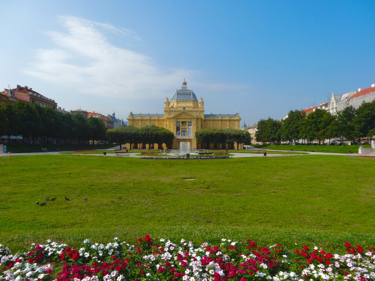 King Tomislav Square, a green square with ornamental fountain, with the Art Pavilion in the background.