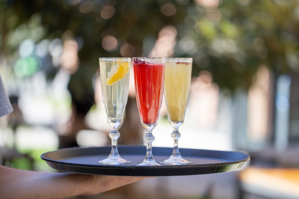 Three glasses of lemonades on a tray.