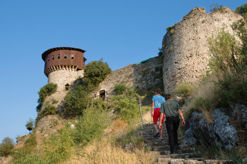 Two visitors go up the stairs that lead to the castle Petrele; the Petrele castle, in ancient times was known as Petralba, is one of the tourist locations close to Tirana and it has two observation towers