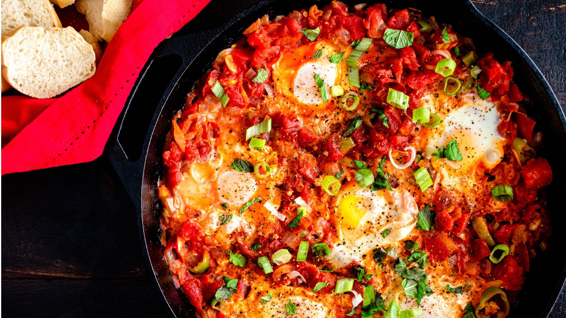 This is a close-up of a cast iron skillet with Turkish menemen eggs with tomato and peppers, a typical dish to try if you want a taste of the best Turkish food.