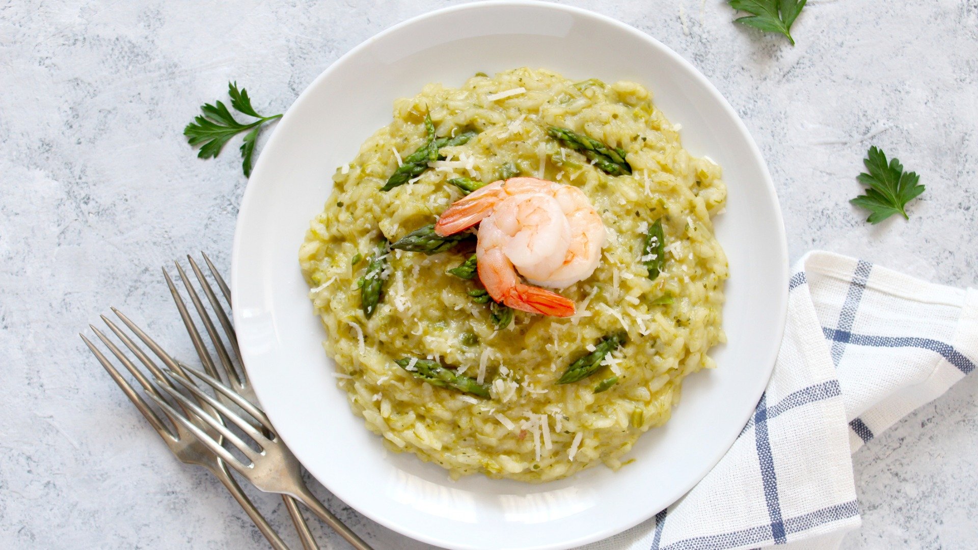 This is a top down image of a dish of Croatian risotto with scampi and asparagus.