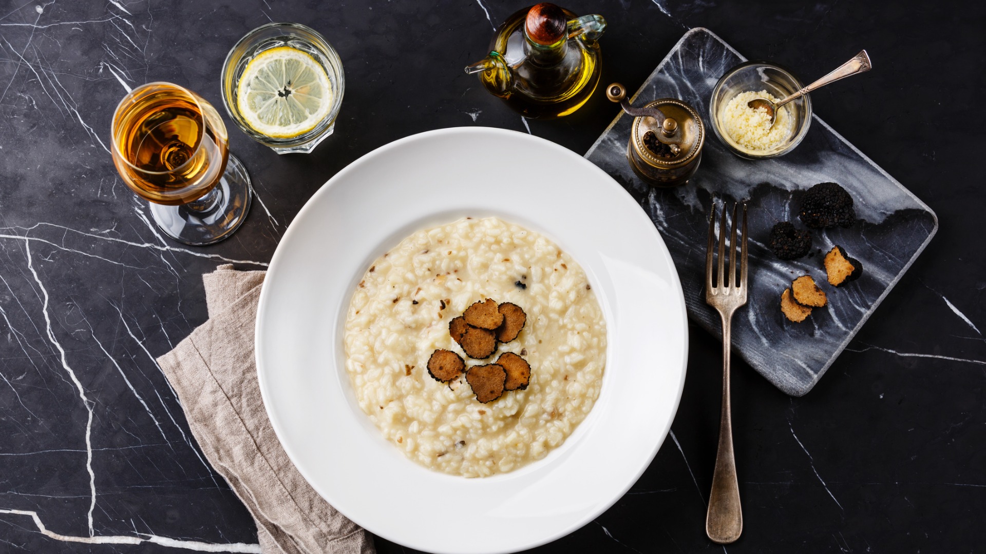 This is a top down image of a dish of Croatian risotto with black truffles. 