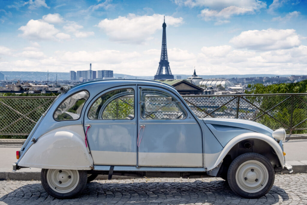 Citroen 2CV vintage car, with the Eiffel Tower in the background.