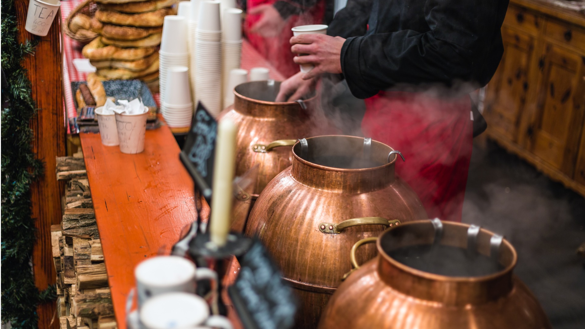 This image shows a man serving mulled wine at a Budapest Christmas market.