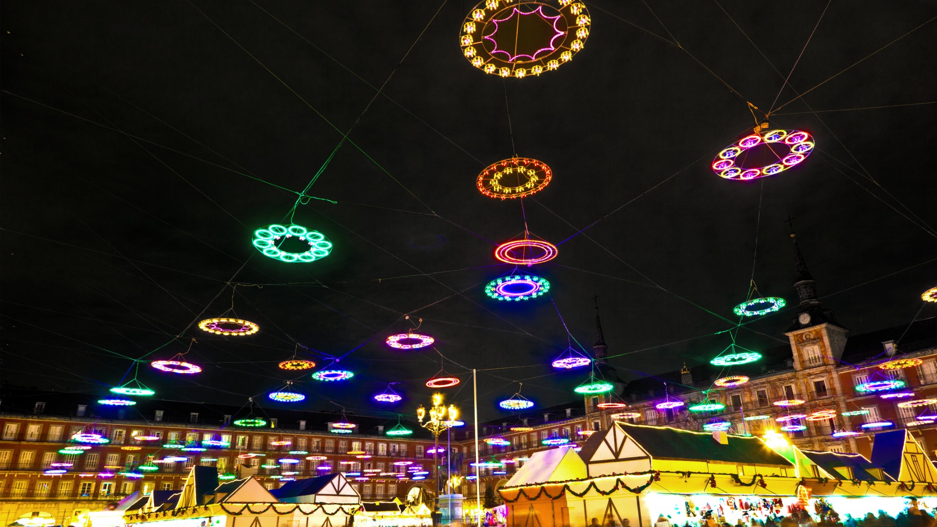 Christmas lights over the stalls of the Christmas market at Plaza Mayor. 