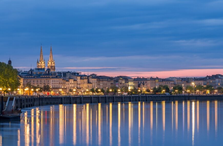 This is a panoramic view of Bordeaux, France, at dusk.