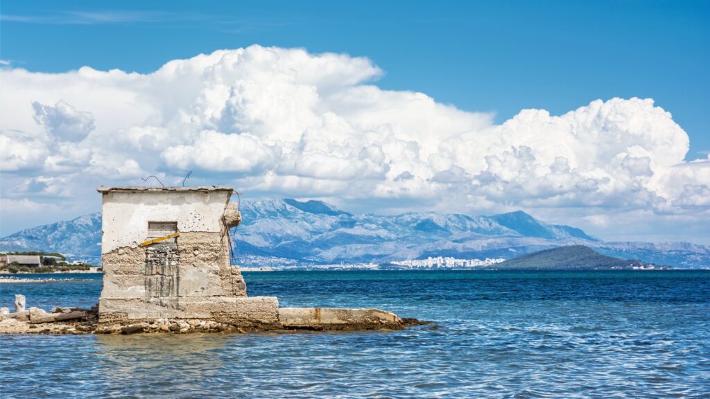 This image shows a semi-ruined building in the sea.