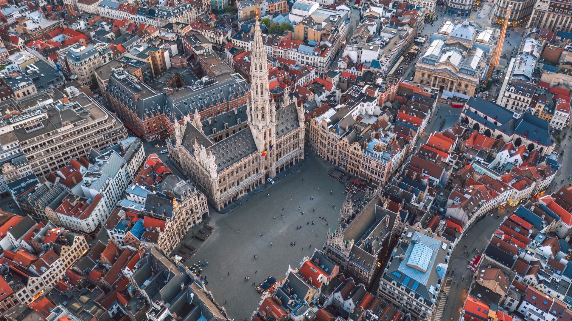 This is an aerial view of Brussels. In the center of the image, the Grand Place is dominated by the city's Town Hall. 