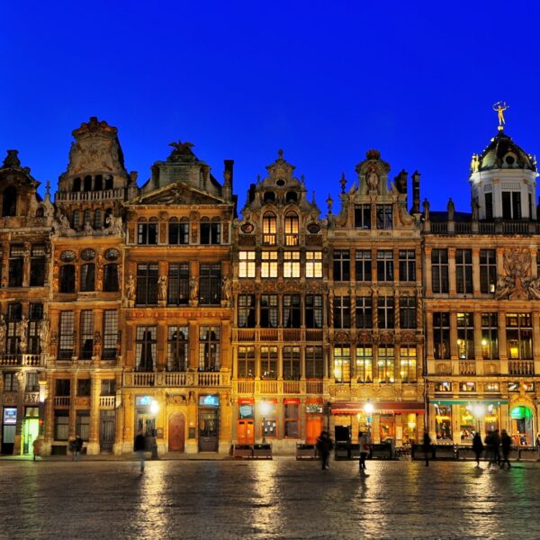 This image shows the magnificent guild houses of Grand Place at dusk.