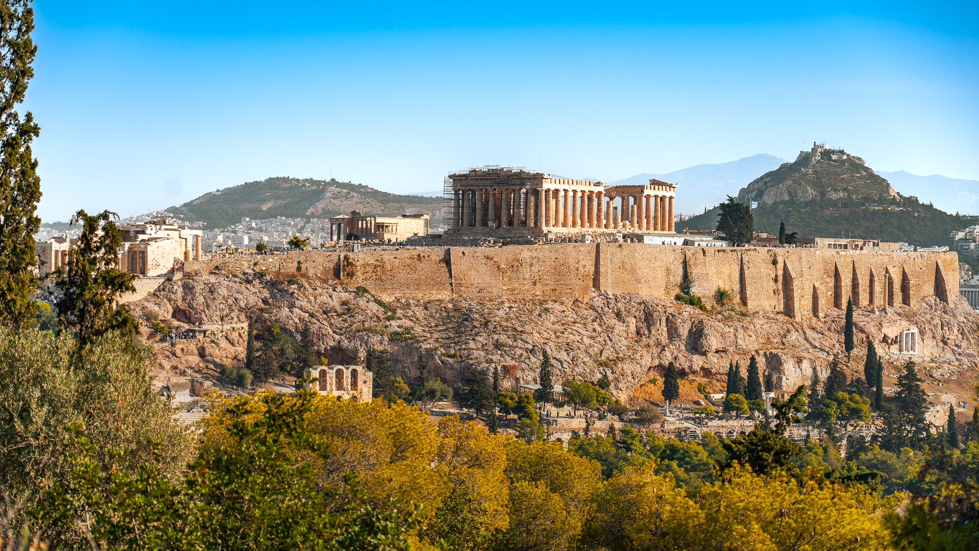 This is a panoramic view of the sacred rock of the Acropolis with Lycabettus Hill in the background. 