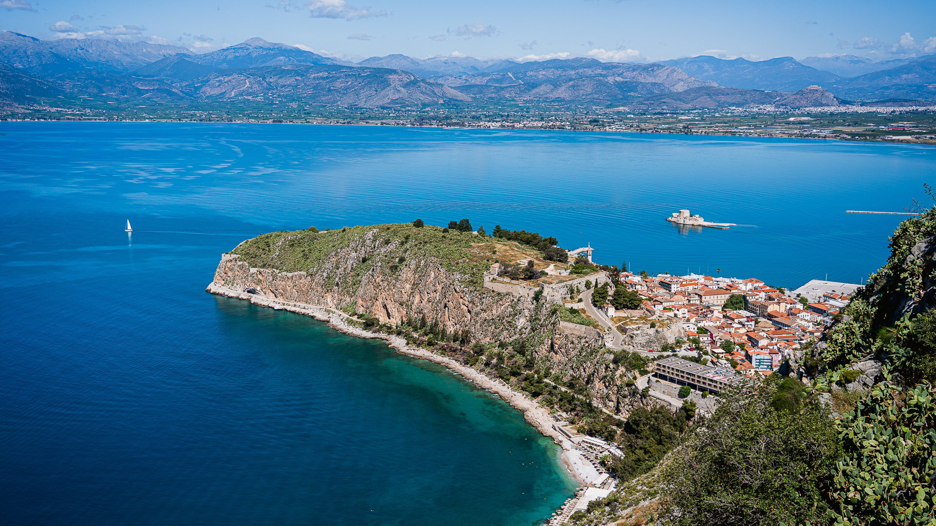 This is a panoramic view of the Akronafplia peninsula in Nafplio, one of the best places on your list of where to travel in Europe in 2024. 
