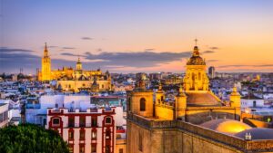 This is a panoramic view of Seville's skyline at sunset.