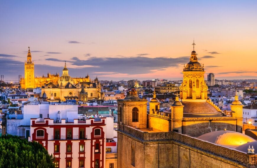 This is a panoramic view of Seville's skyline at sunset.