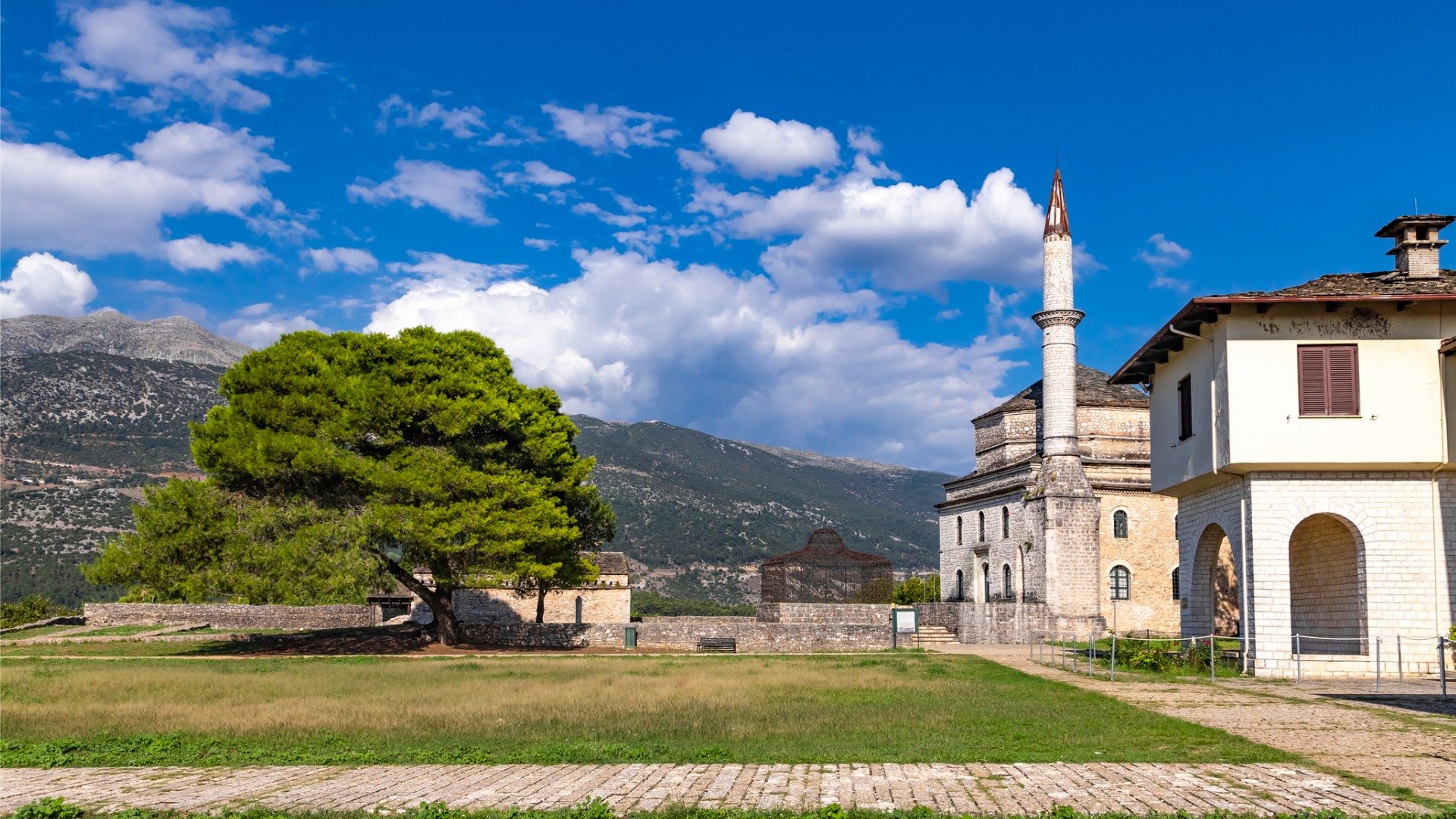 This image shows a mosque and a traditional Epirus building, both within the grounds of the Castle of Ioannina. 