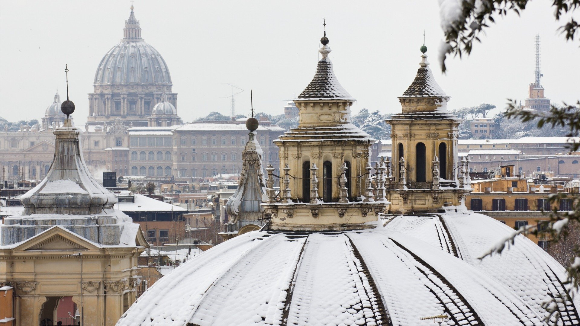 This is a close up of Rome's skyline with snow on the rooftops. 