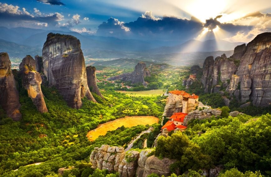 This is a panoramic shot of the Meteora rocks at sunset.