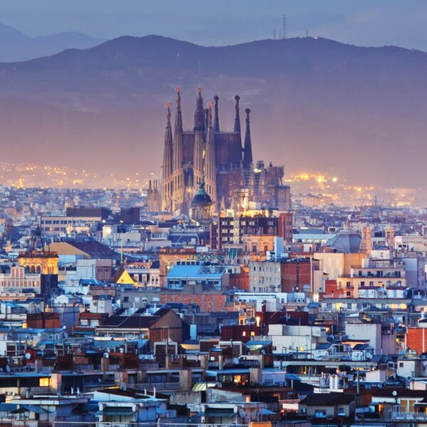 This image shows the skyline of Barcelona dominated by La Sagrada Familia in the blue hour.