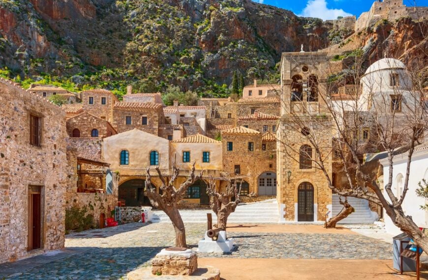 This image shows the main square inside the castle town of Monemvasia. There are medieval houses and a bell tower.
