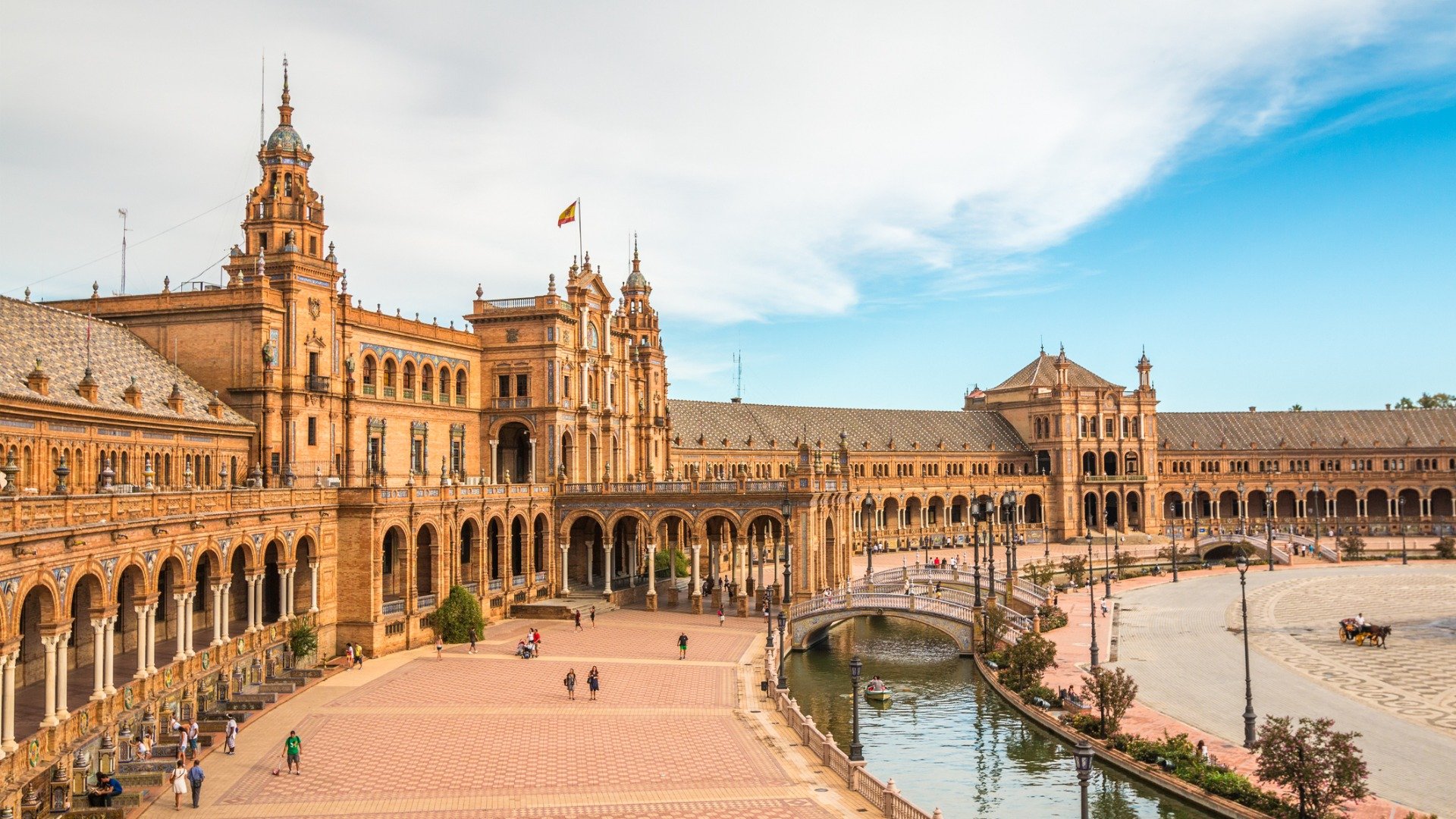The buildings and canal of Plaza de Espana in Seville, one of the best places to visit in Spain. 