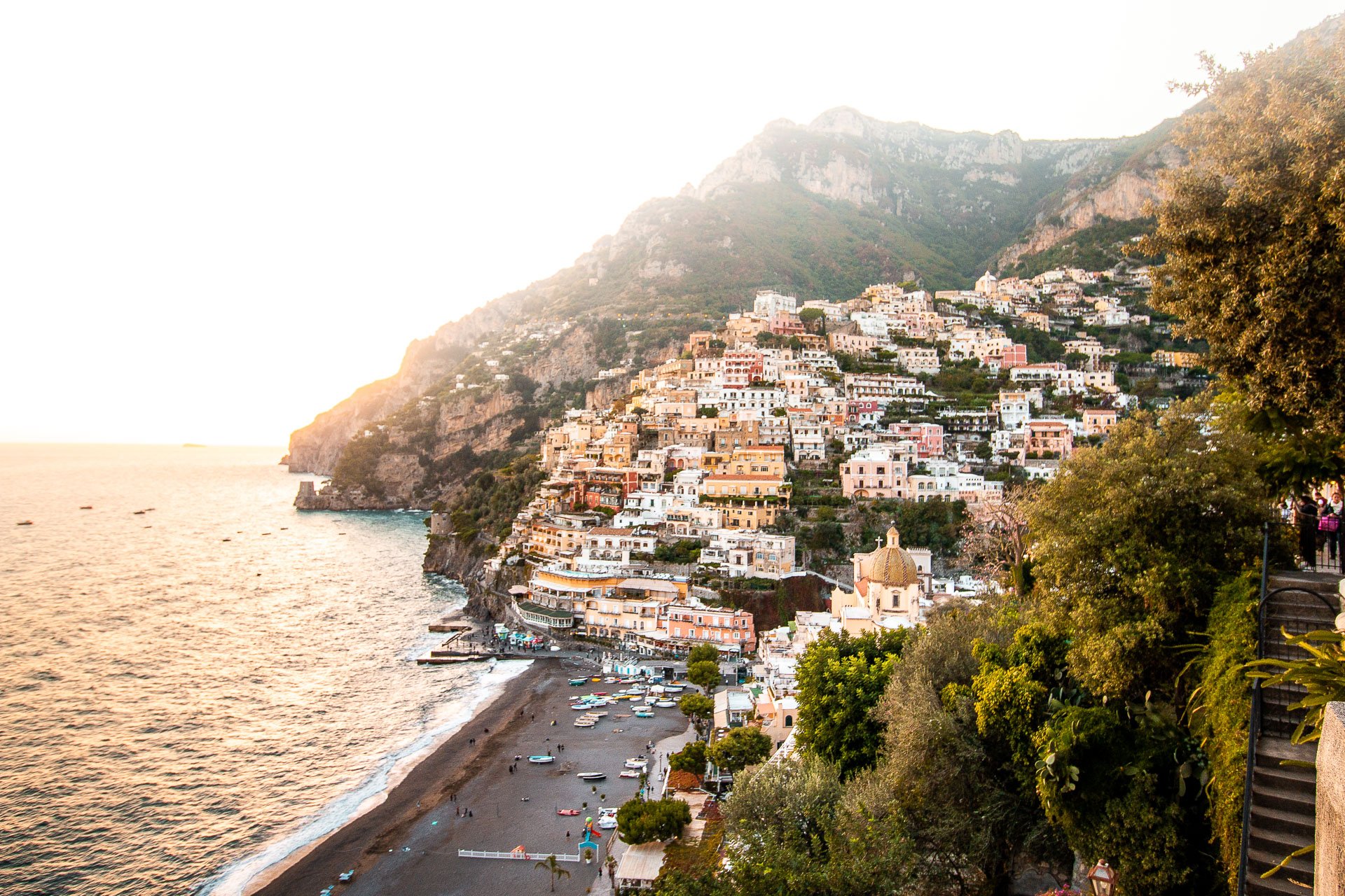 This is a panoramic view of Positano with its buildings perched on a steep slope by the sea. 