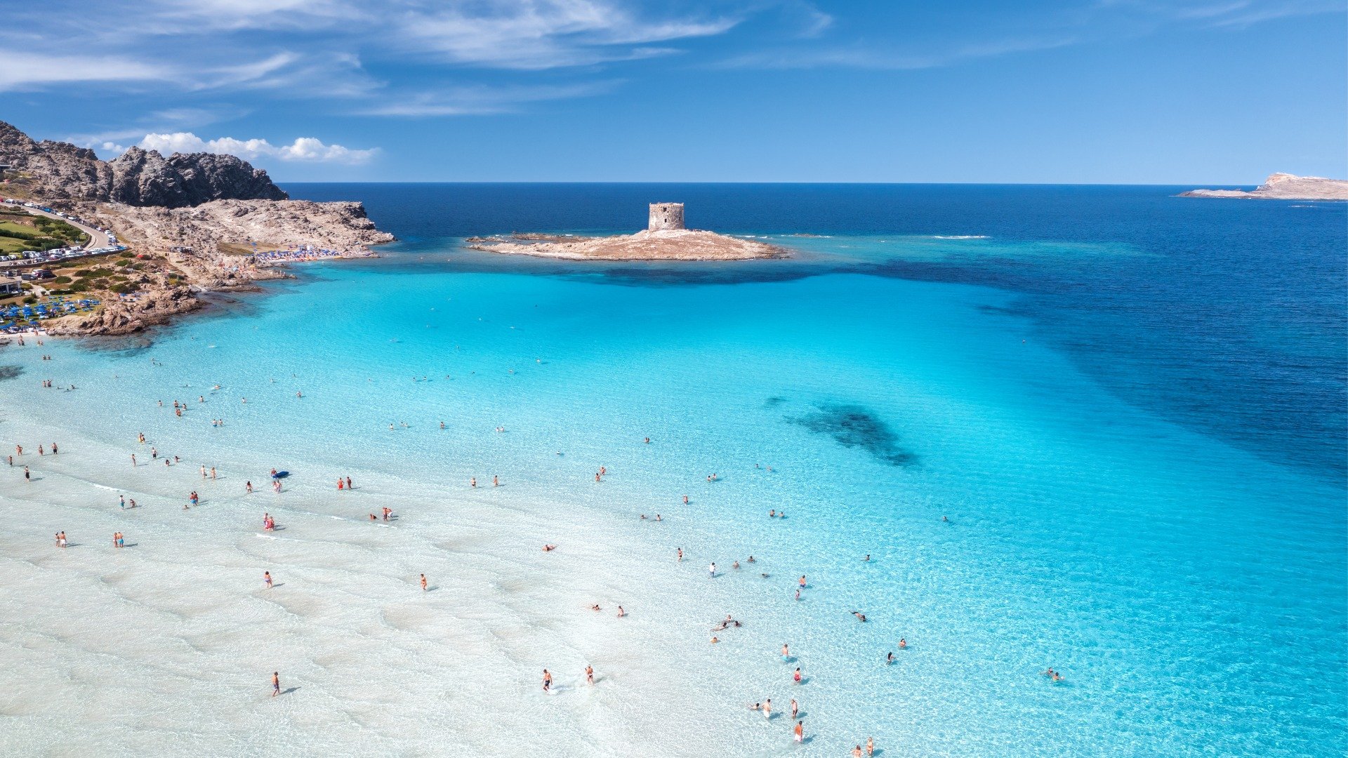 This is a panoramic shot of the transparent waters of La Pelosa Beach in Sardinia.