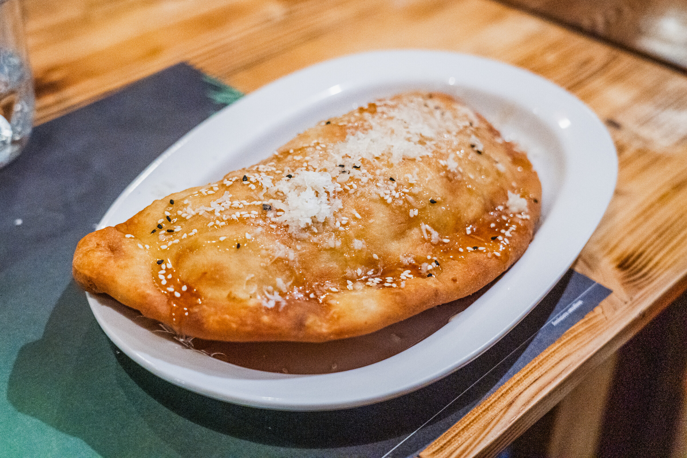 A close up of a deep-fried cheese pie. 