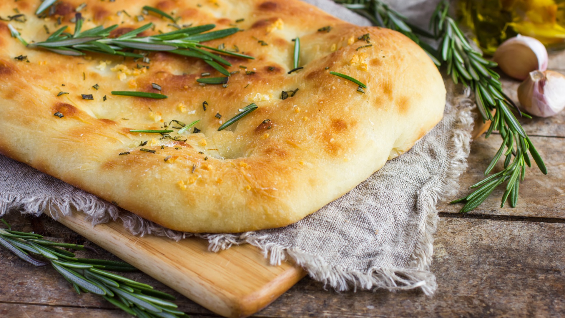 A close up of Focaccia bread with rosemary. 