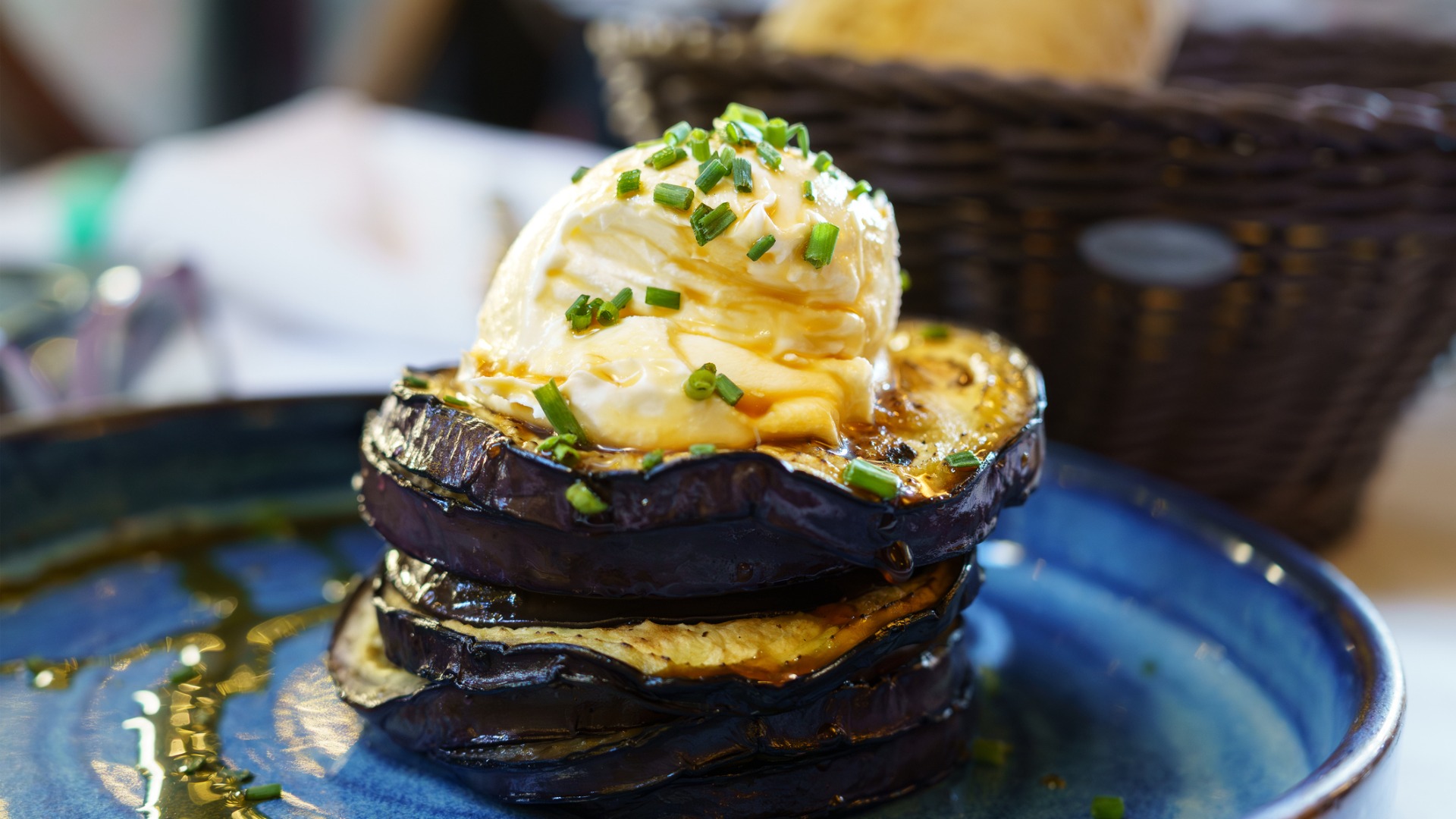 This image shows slices of eggplant with a cheese-based cream on top. 