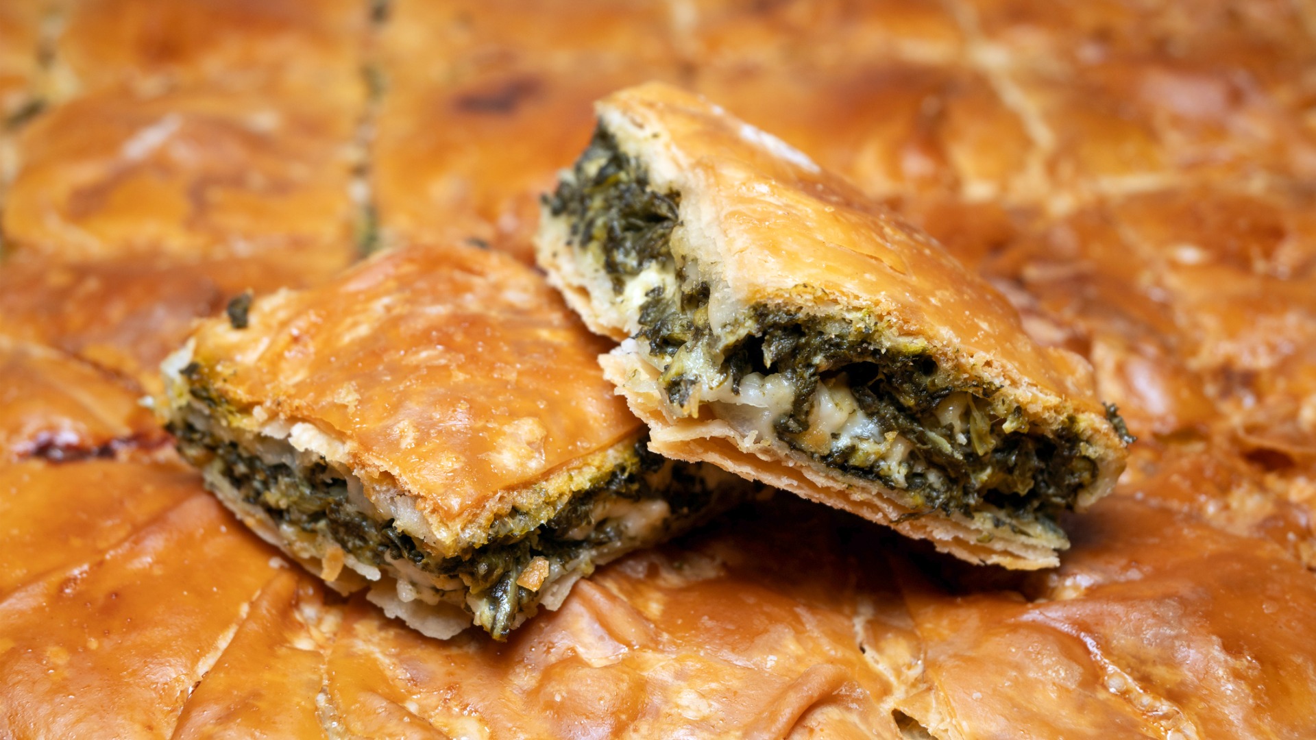 A close up of two pieces of spinach pie, for many the best Greek food to try. 