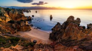 A panoramic view of Praia do Camilo at sunset.