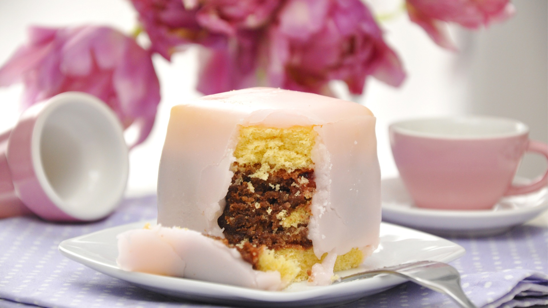 A close-up of a pink Punschkrapfen cake, one of the best desserts in Vienna.  