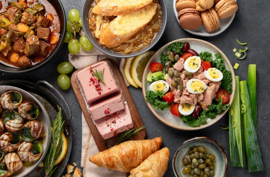 A selection of typical French dishes, such as Escargots, Salade Nicoise, French Onion Soup, and Croissants.