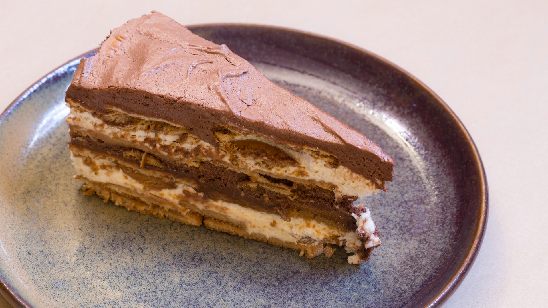 A close up of a slice of Bolo de Bolacha, a layered cake that couldn't be left out of this list of the best Portuguese food. 