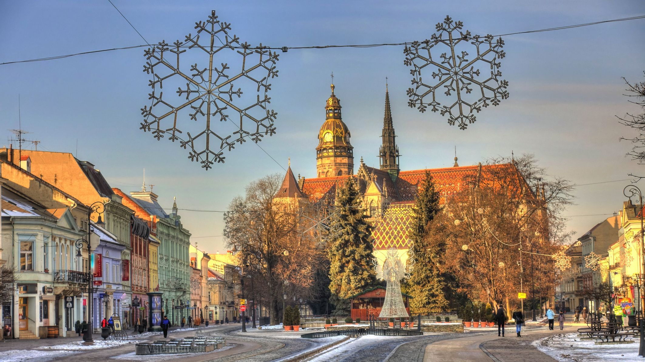 A beautiful street with snow and Christmas decorations.