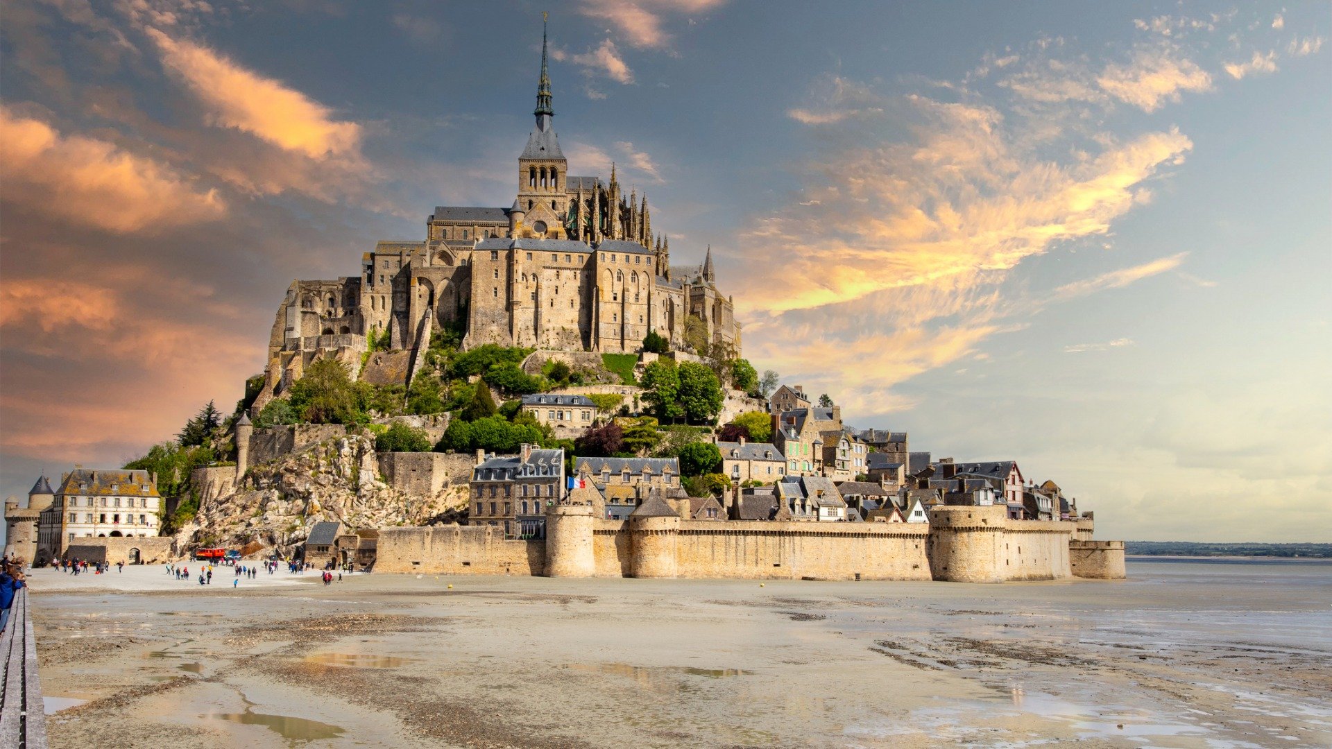 A castle built on a rock in the sand. 