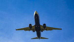 A close-up of a Ryanair plane under a bright blue sky.