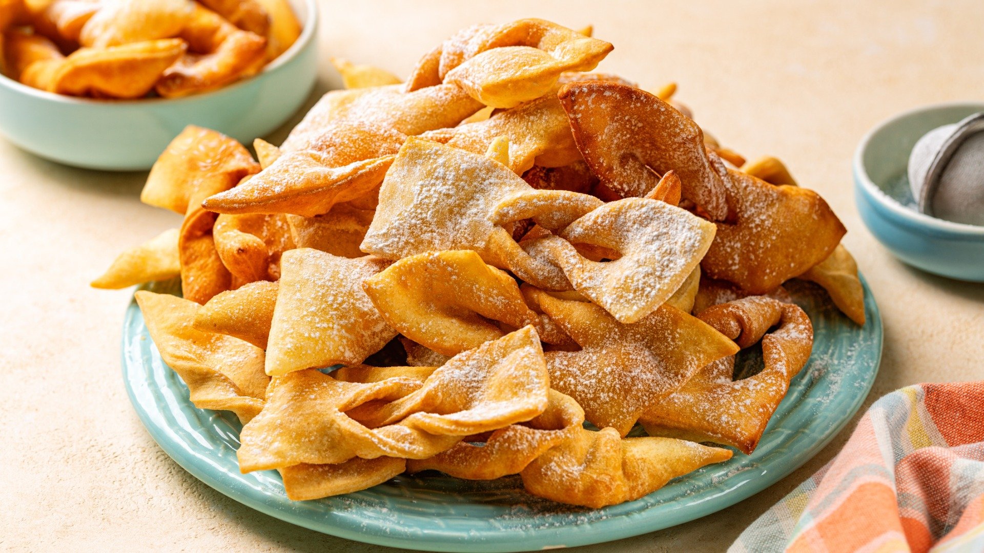 A light blue plate filled with Faworki treats. 