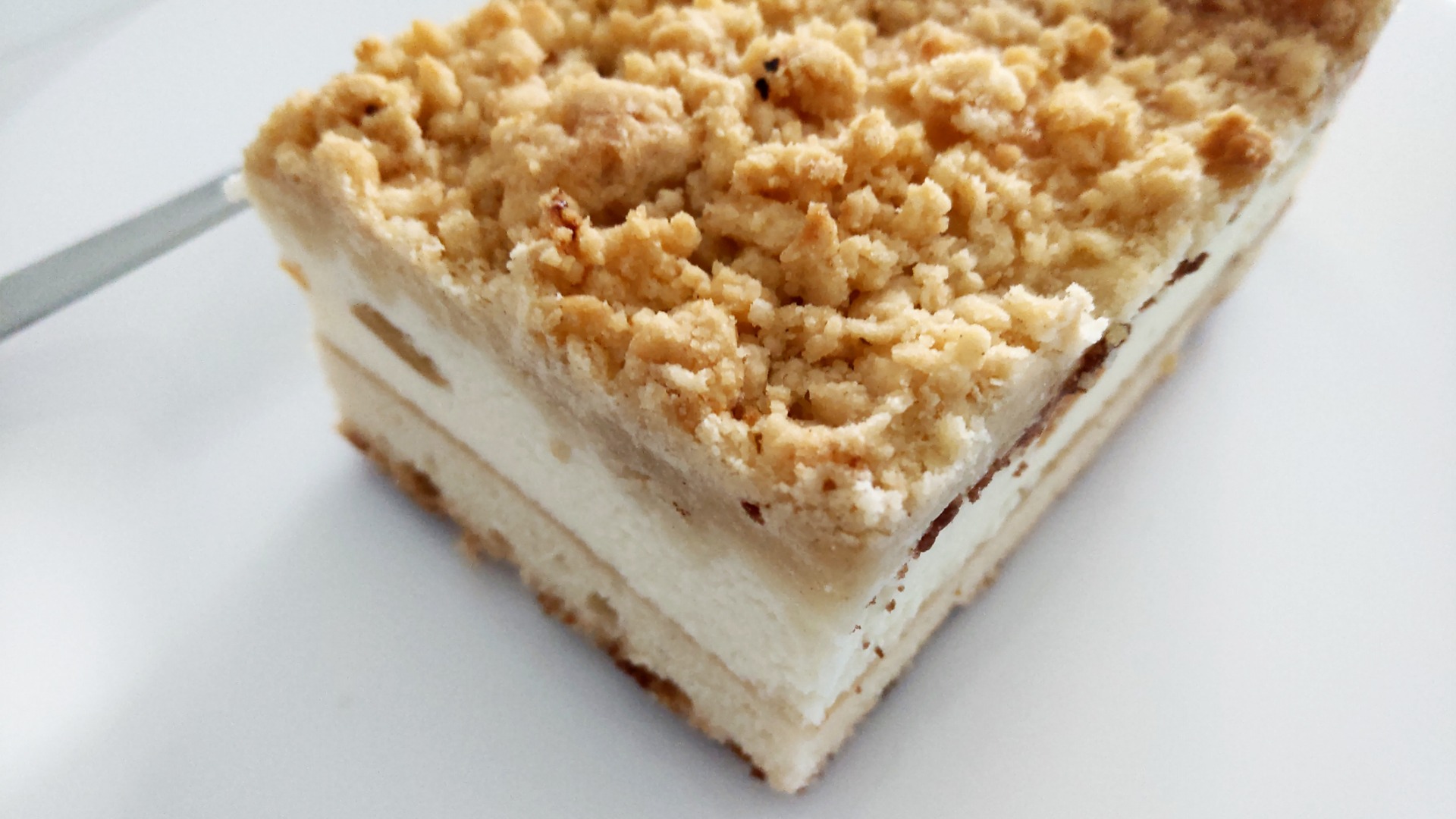 A close up of a layered crumb cake. 