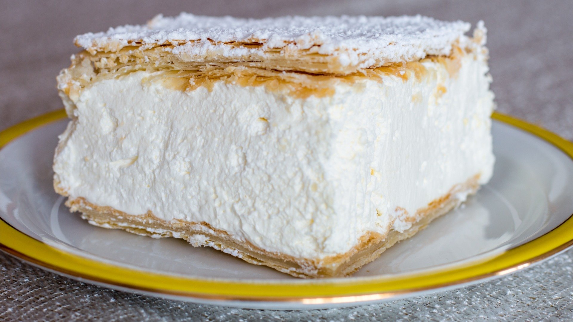 A close up of a large piece of a cream-filled dessert. 